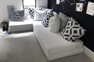 large white floor cushions with black and white pillows