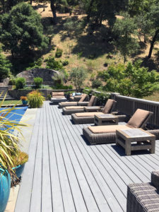 row of wicker chaise with hinged beige cushions