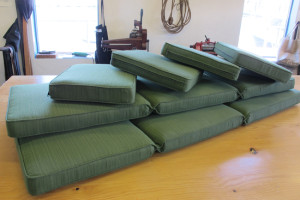 stack of green patio cushions