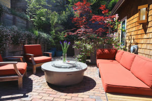 brick patio with red couch and chair cushions