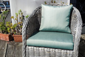 wicker chair with light green cushions