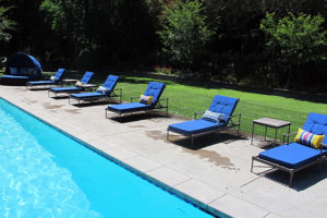 Poolside Chaise lounge chairs with blue cushions